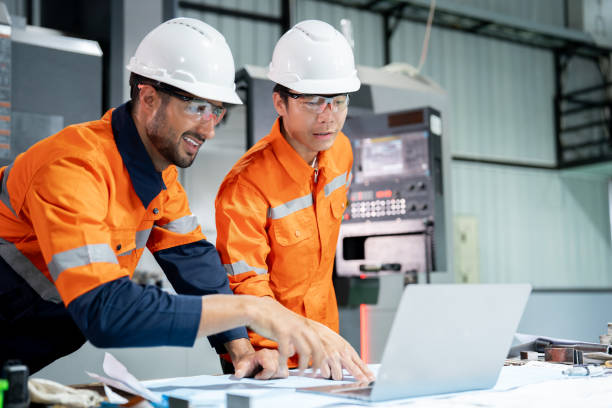 istock Multiracial engineer team collaborates in a factory brainstorm, uniting diverse skills for innovative solutions. 2063257373