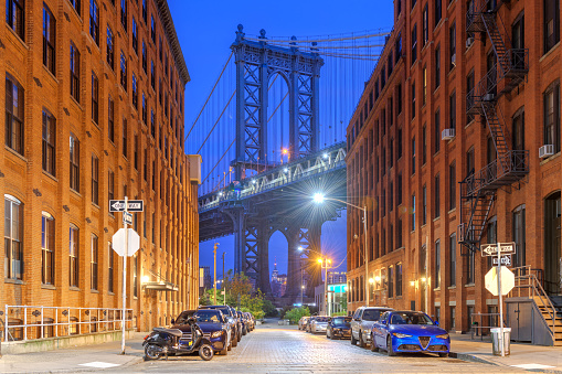 Cityscape with the Manhattan Bridge from Brooklyn at blue hour in New York City.
