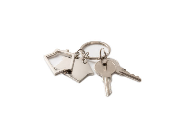istock Keychain with key ring isolated on a colored background. Concepts for real estate and moving home or renting property. Buying a property. Mock-up keychain.Copy space. 2063267404