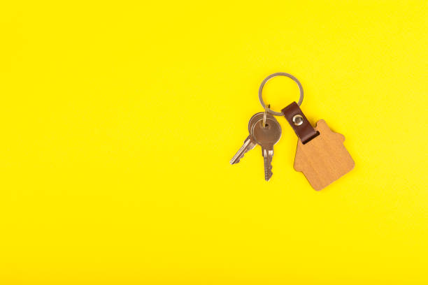 istock Keychain with key ring isolated on a colored background. Concepts for real estate and moving home or renting property. Buying a property. Mock-up keychain.Copy space. 2063267914
