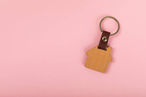 istock Keychain with key ring isolated on a colored background. Concepts for real estate and moving home or renting property. Buying a property. Mock-up keychain.Copy space. 2063267932
