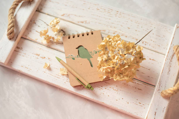 istock Notepad and dried flowers on a white wooden background. View from above. 2063271697
