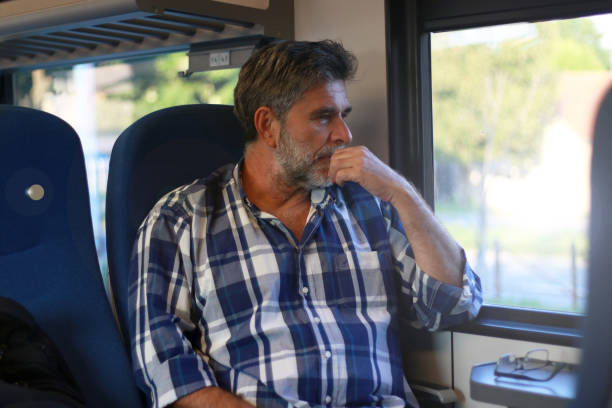 istock Mature bearded man sitting in train and travel 2063275965