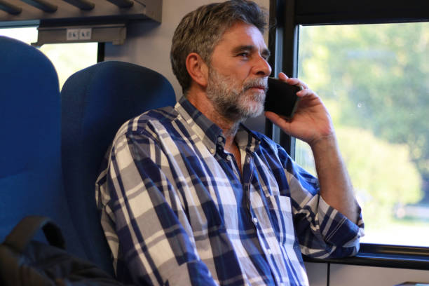 istock Mature bearded man sitting in train and travel 2063278641
