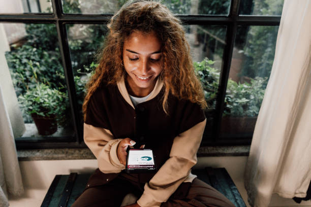 Teenager checking savings account on mobile app