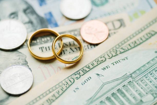 istock Wedding rings and USD bills 2063294945