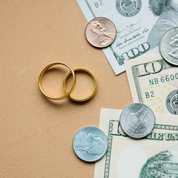 istock Wedding rings and USD bills 2063294967