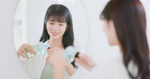 istock asian woman happily mouthwash teeth 2063300346