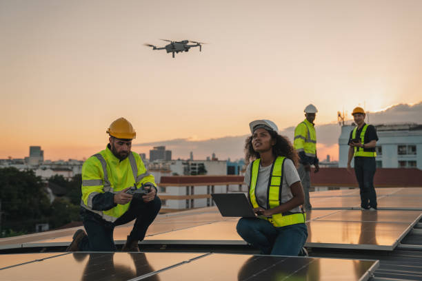 istock Service engineer checking solar cell on the roof for maintenance with drone technology. Engineer worker install solar panel. Clean energy concept. 2063301403