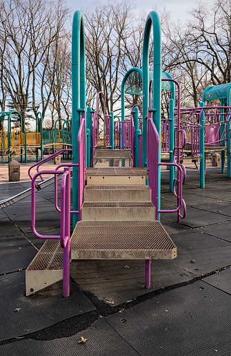 children's playground detail with slide and monkey bars (urban park play area with rubber mats, jungle gym for kids) colorful empty toys for children in new york city (brooklyn mount prospect) fun