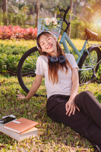 person with bike in nature park in vacation and mental wellbeing. - mental health women asian ethnicity bicycle zdjęcia i obrazy z banku zdjęć