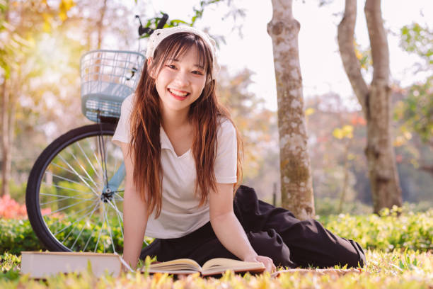 person with bike in nature park in vacation and mental wellbeing. - mental health women asian ethnicity bicycle zdjęcia i obrazy z banku zdjęć