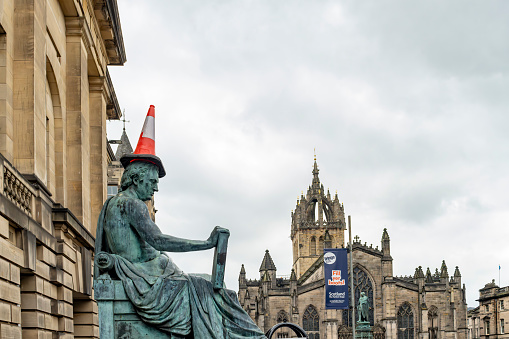 Royal Mile, Edinburgh, Scotland, August 2023. Edinburgh's David Hume statue on the Royal Mile, during the fringe it often gets random objects to wear.