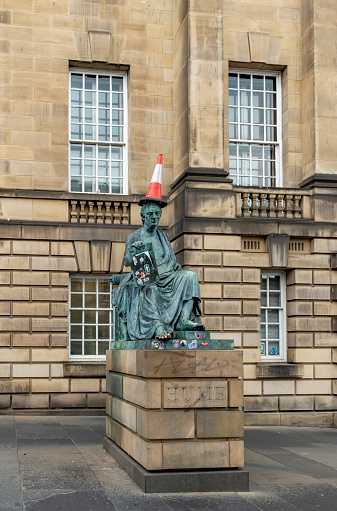 Royal Mile, Edinburgh, Scotland, August 2023. Edinburgh's David Hume statue on the Royal Mile, during the fringe it often gets random objects to wear.