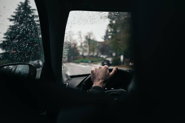 istock driving car in rainy days. 2063349636