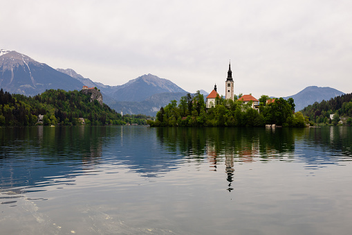 Lake Bled (Blejsko Jezero) in Slovenia with the famous church (Assumption of Mary) on the island. The Bled Castle can be seen in the distance.