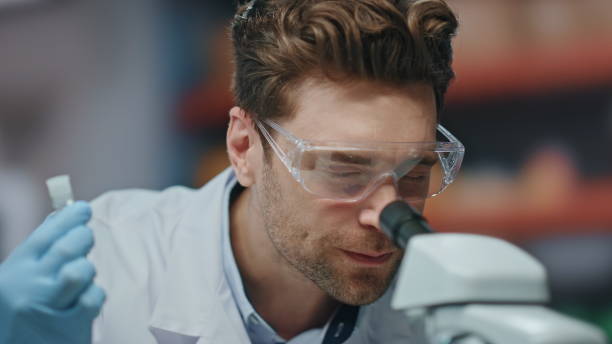 istock Excited scientist working microscope rejoicing research in laboratory close up. 2063388551