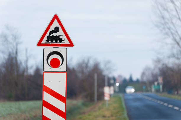 Level crossing without barrier ahead sign with a car in Hungary