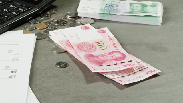 Detailed close up of 100 Yuan, the Chinese currency. 100 Renminbi the highest denomination of china's money. Footage of chinese banknotes. Counting money, finance