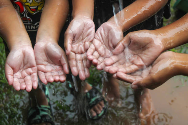 hands with splashes of falling rainwater