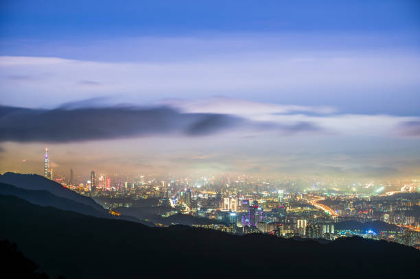 istock Rolling clouds and city lights enrich the night scene. 2063440032