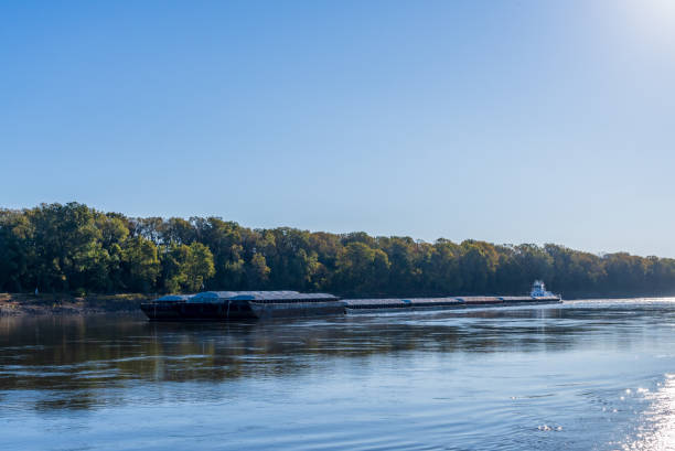 istock Tug boat pusher behind freight barges loaded with grain on Mississippi River 2063448149
