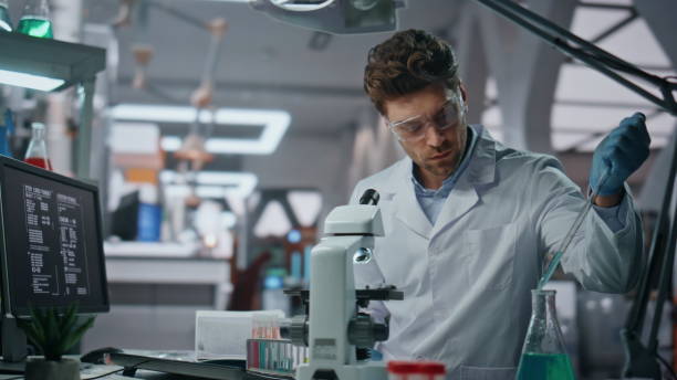istock Young microbiologist experimenting medicines in clinic laboratory close up. 2063448151