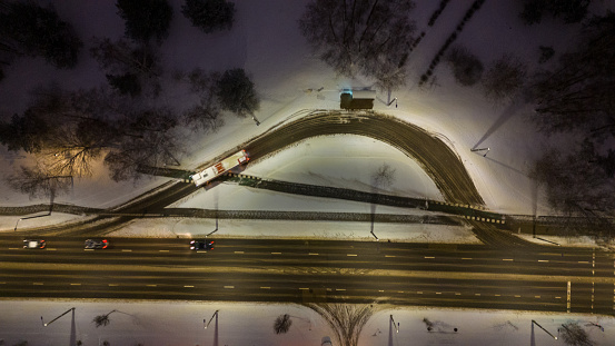Drone photography of a bus stop near a road road in a city during winter cloudy morning
