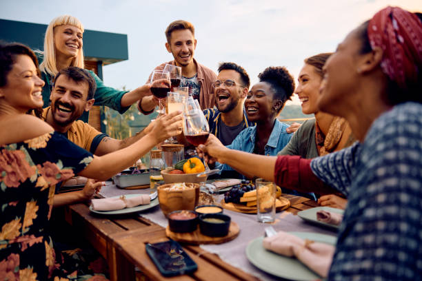 istock Happy friends having fun and toasting while gathering on lunch party on a patio. 2063454551