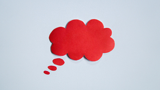 Red paper speech bubble on white background. Blank space that can be added text.