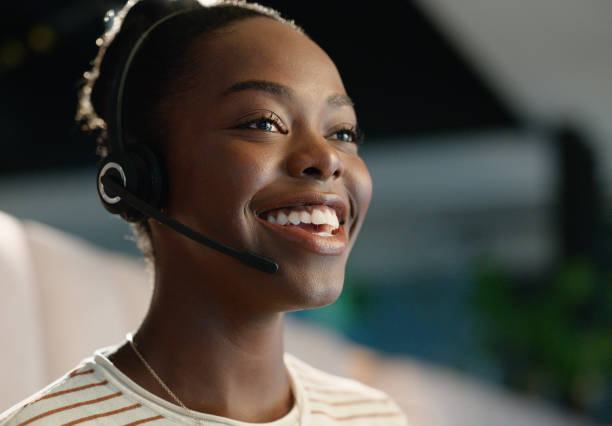 istock Call centre, night and black woman with headset for communication, support or customer service. Happy, virtual and face of sales agent speaking for telemarketing, consultation or online assistance 2063468333