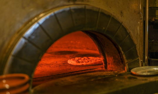 Pizza baking in red-hot pizza oven
