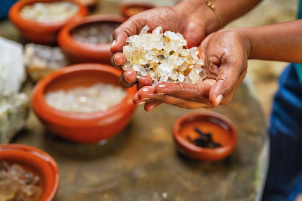 istock Woman hold washed mined gemstone, on table are many bowl with gemstone. 2063479356