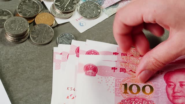 Detailed close up of 100 Yuan, the Chinese currency. 100 Renminbi the highest denomination of china's money. Footage of chinese banknotes. Counting money, finance
