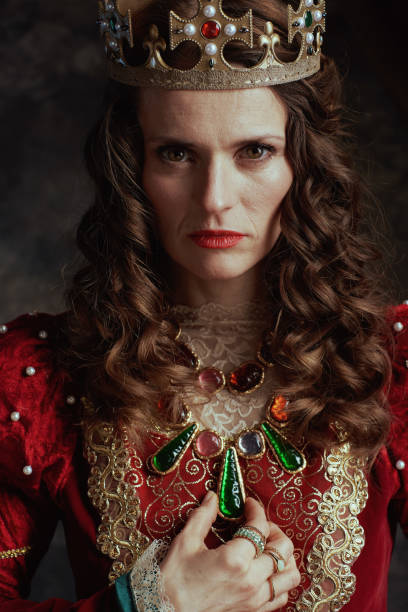istock medieval queen in red dress with crown 2063501347