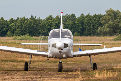 Front view of the private single-engined piston-powered aircraft taxiing at the airfield