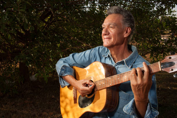 istock Man at a park playing his guitar 2063566235