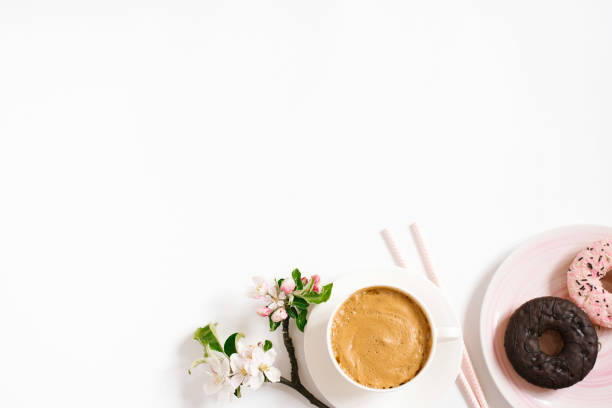 istock Stylish flat lay with cappuccino cup, apple blossoms, donuts on a white background with space copying. Morning breakfast or coffee break 2063586547