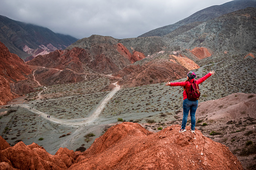Young woman on vacation in Purmamarca, Jujuy, Argentina. Young woman traveling through northern Argentina. Tourist touring beautiful and colorful mountains of Purmamarca, Argentina