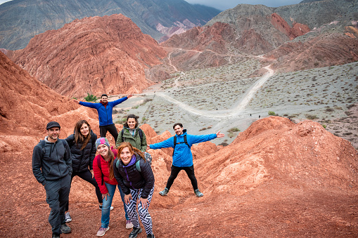 Group of friends on vacation in Purmamarca, Jujuy, Argentina. Group of friends traveling through northern Argentina. Tourists touring beautiful and colorful mountains of Purmamarca, Argentina