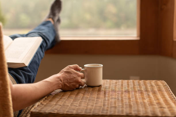 istock Man reading book and drinking coffee at home in the morning. 2063603082