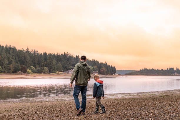 Father and son walking on the beach.