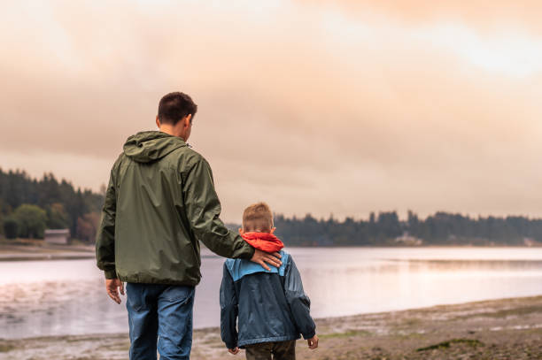 istock Father and son walking on the beach in Washington state. 2063617382