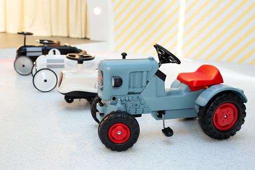 Small children's cars with pedals in the children's play area