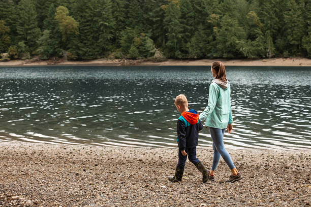 istock Mother and son walking by the river together. 2063622743
