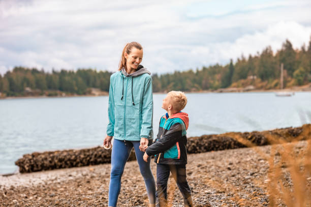 istock Mother and son taking a walk on the beach. 2063624956