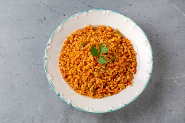 istock Traditional turkish bulgur pilaf with tomato sause in plate (Turkish name; meyhane pilavi) 2063657633