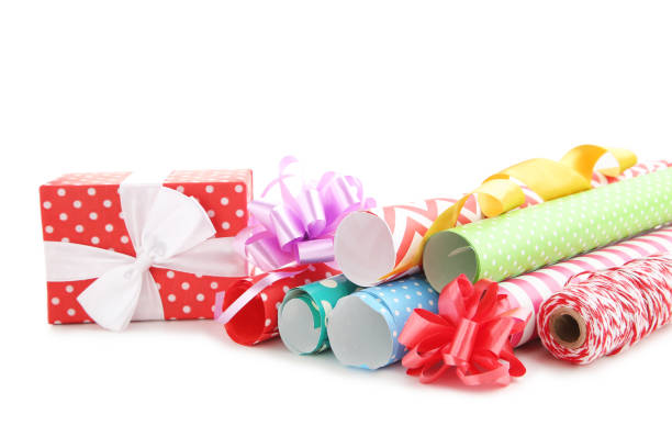 istock Rolls of craft papers with ribbon bows and gift box on white background 2063663460