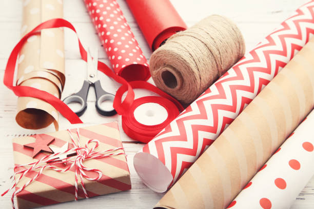 istock Rolls of craft papers with gift box and scissors on white wooden background 2063675128