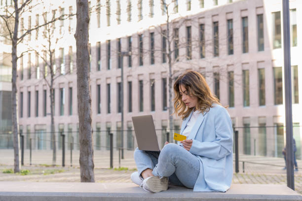 istock woman shooping online sitting on the bench 2063688554